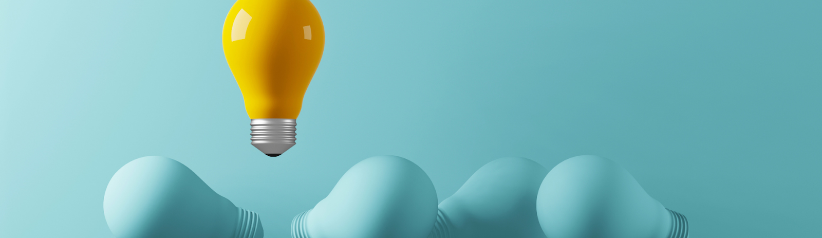 Yellow lightbulb standing out among blue ones on a blue background.